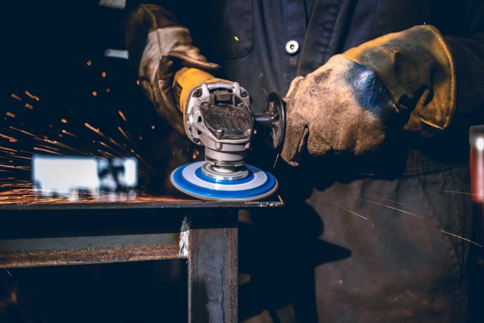 person using grinder tool